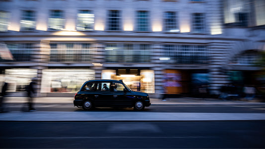 Photo showing a London black cab driving through the city.