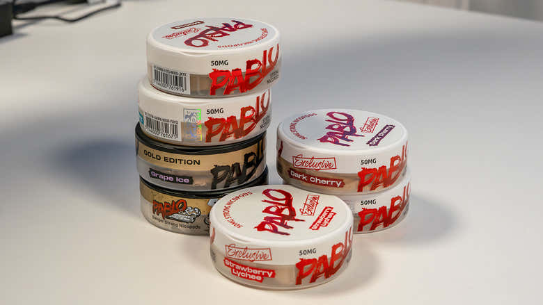 Containers of putty stacked on a table.