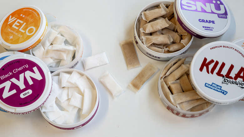 Various containers of tobacco-free nicotine pouches on a white background.