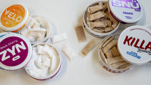 Various containers of tobacco-free nicotine pouches on a white background.